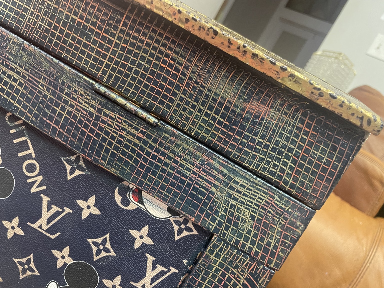 Close view of the layered hand-finished texture on the designer chest