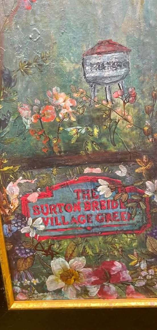 Close view of layered flowers and the hand-painted Burton Bridge Village Green detail