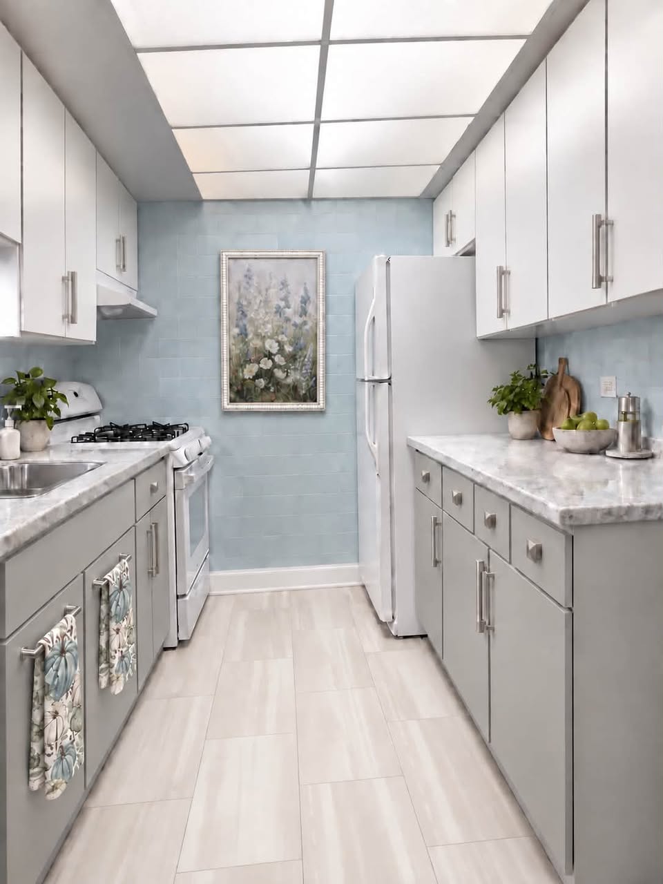 Finished kitchen refresh with Pure White upper cabinets, Argos base cabinets, new hardware, and glazed blue tile