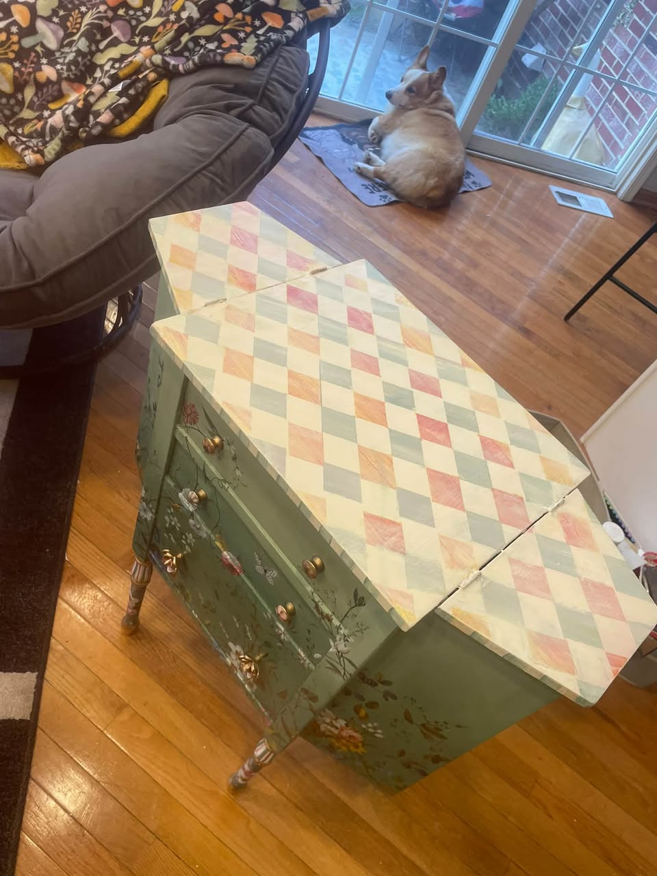 Top view of the refinished Martha Washington cabinet showing its pastel harlequin pattern and resin-sealed surface
