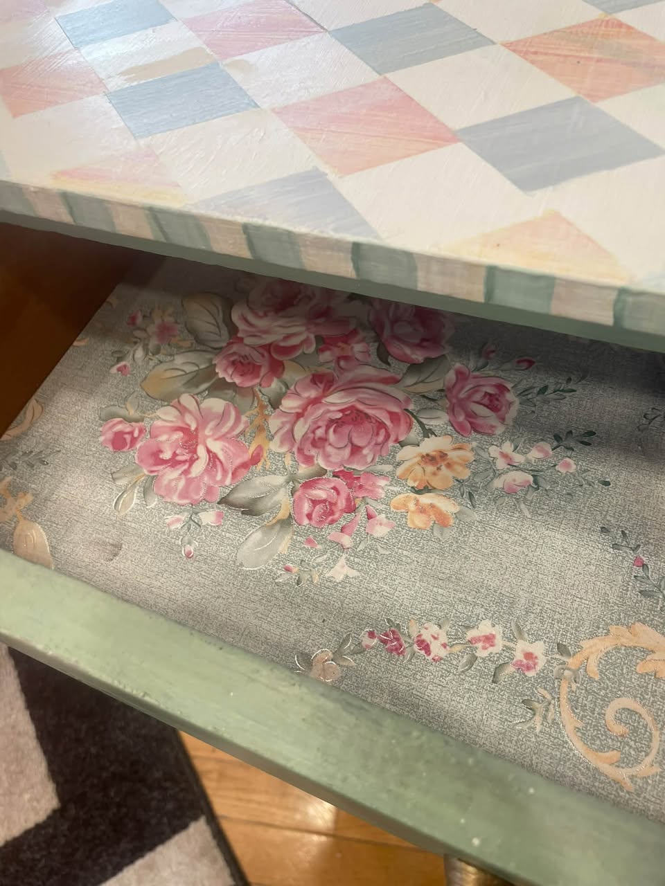 Close view inside a drawer of the Martha Washington cabinet showing the decorative rose-lined interior