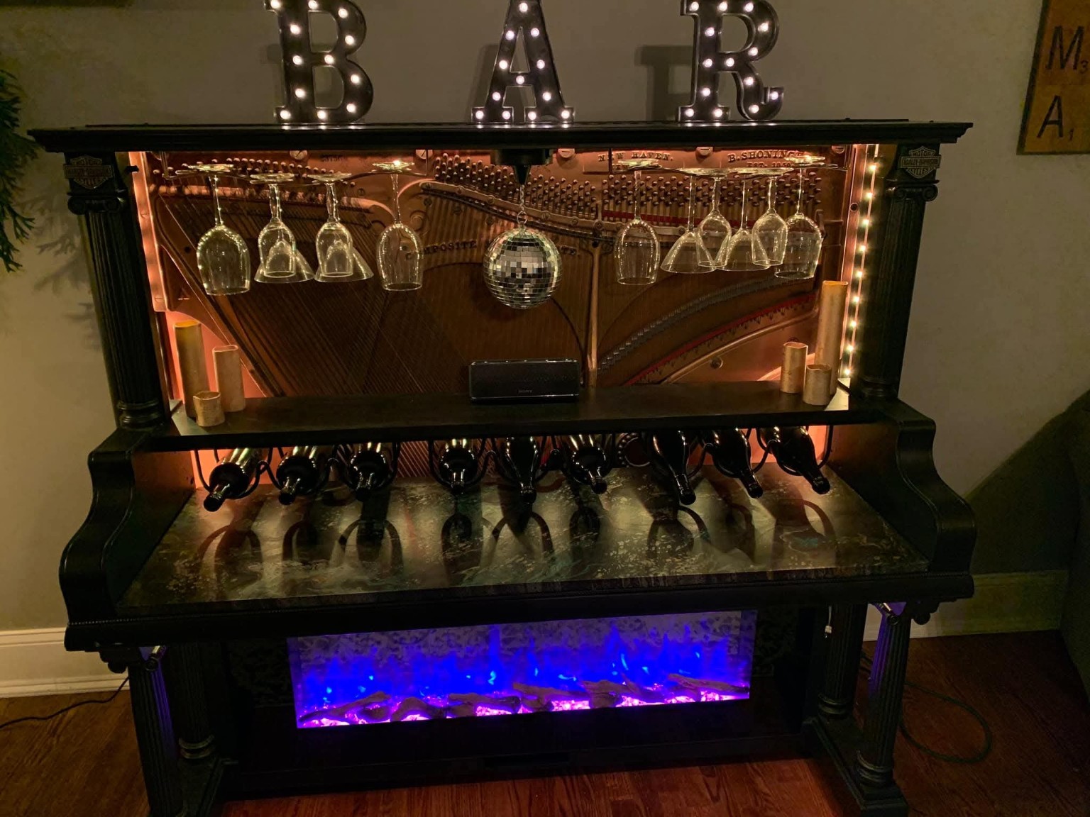 Custom piano bar illuminated with warm white accent lighting