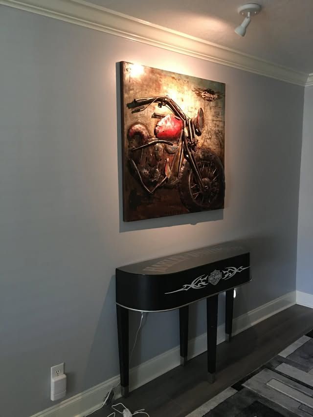 Black console displayed beneath dimensional custom wall art