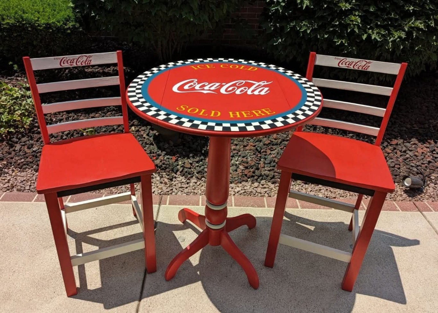 Red Coca-Cola bistro table and two matching hand-painted chairs