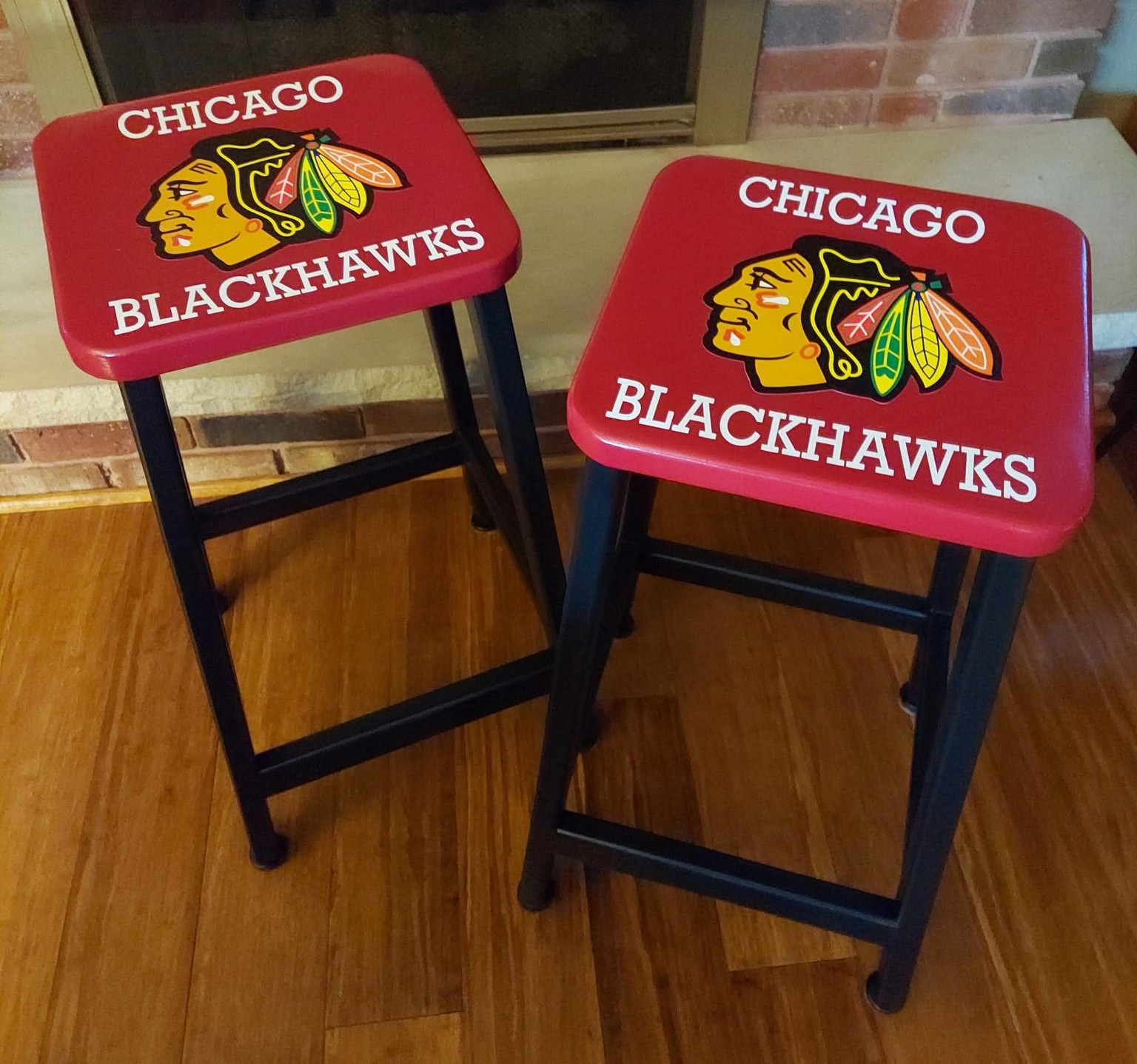 Two custom red and black Chicago Blackhawks bar stools